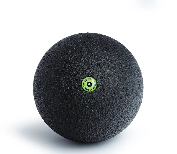 Black massage ball with a green logo on a white background