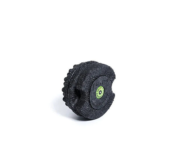 Black textured foam roller with a green logo on a white background