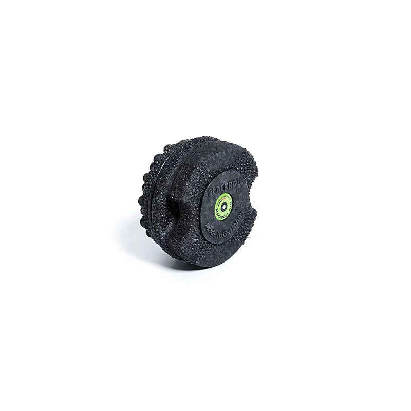 Black textured foam roller with a green logo on a white background