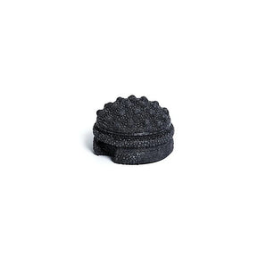 black textured massage ball on a white background