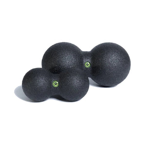 Two black massage balls with green accents on a white background